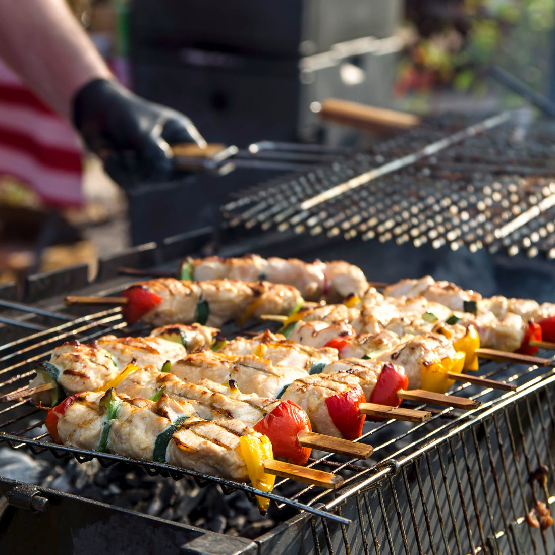 Square stainless steel roaster with wooden handle for grilling.