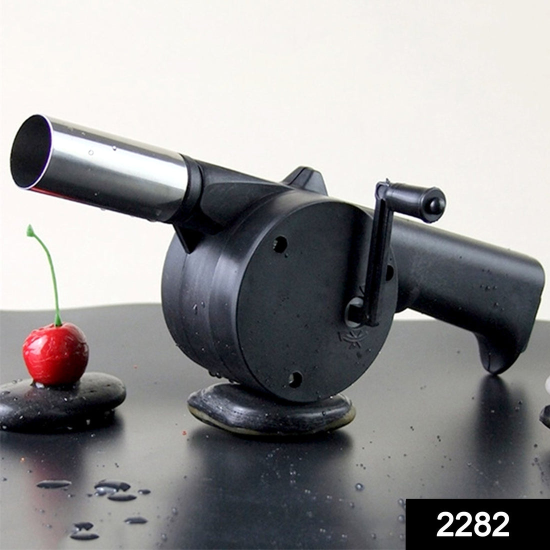 Portable hand crank air blower for charcoal grilling and BBQs.
